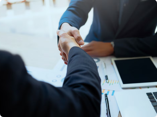 two people on suits shaking hands